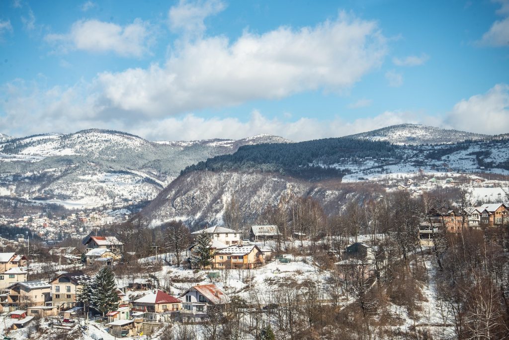 Snow-covered hills and houses overlooking Sarajevo in winter