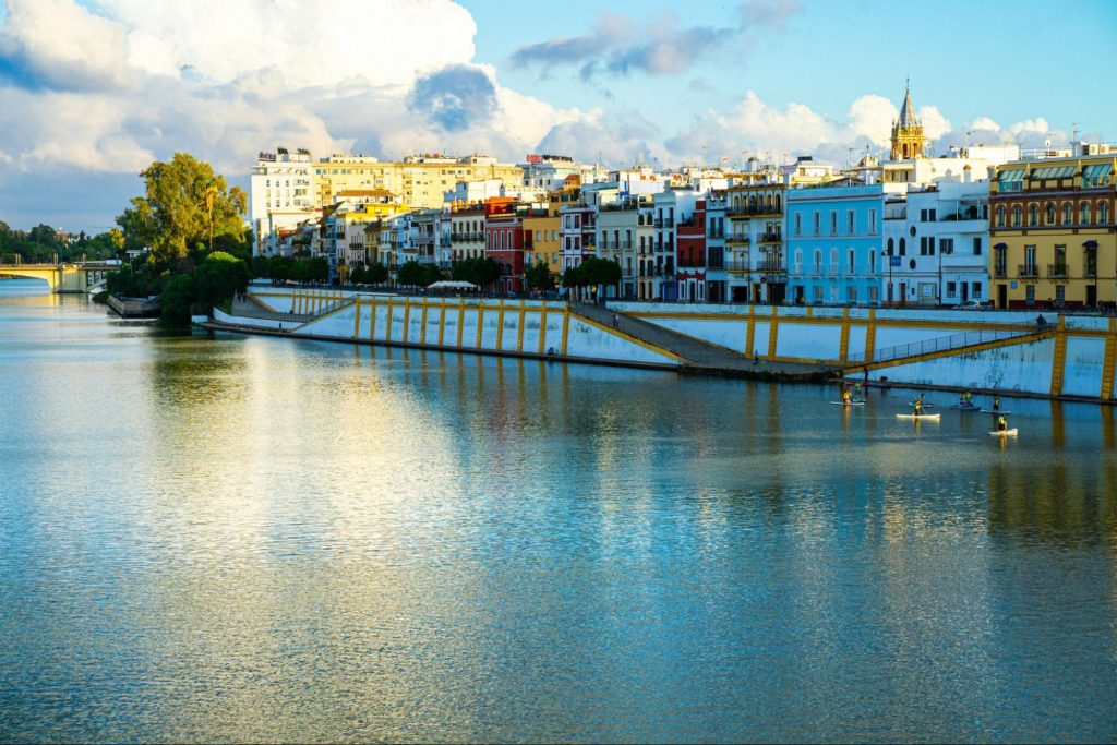 Guadalquivir riverfront with colorful buildings in Seville