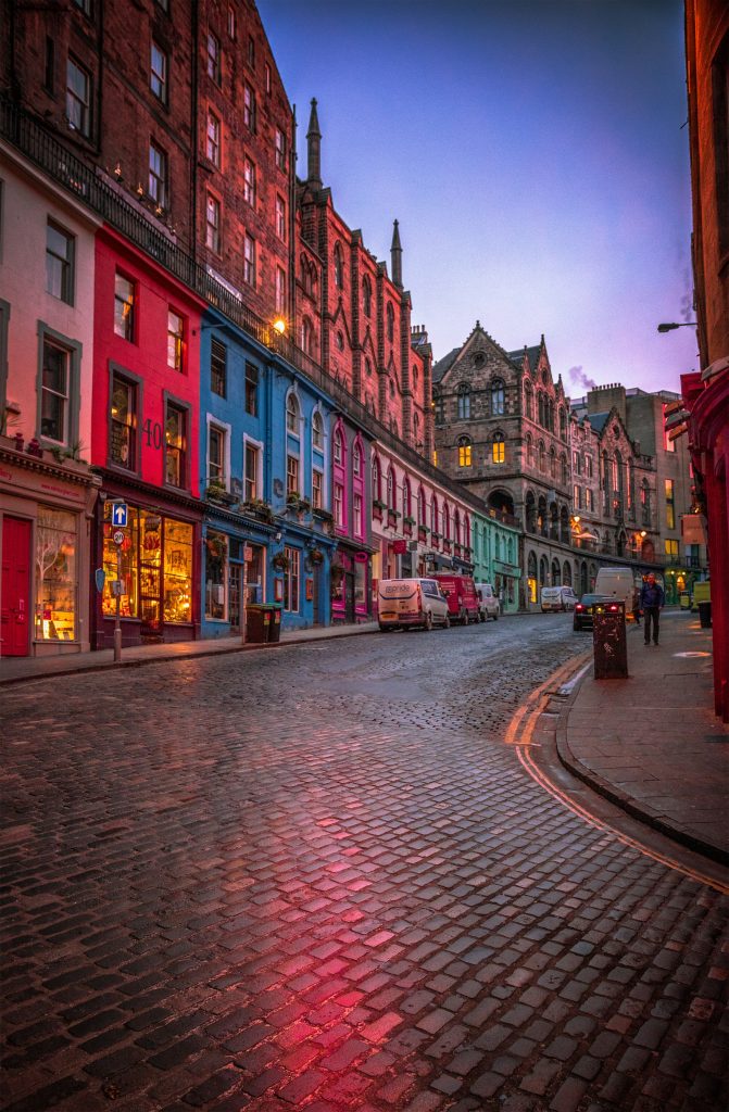 Colorful buildings and cobbled street in Edinburgh Old Town at dusk