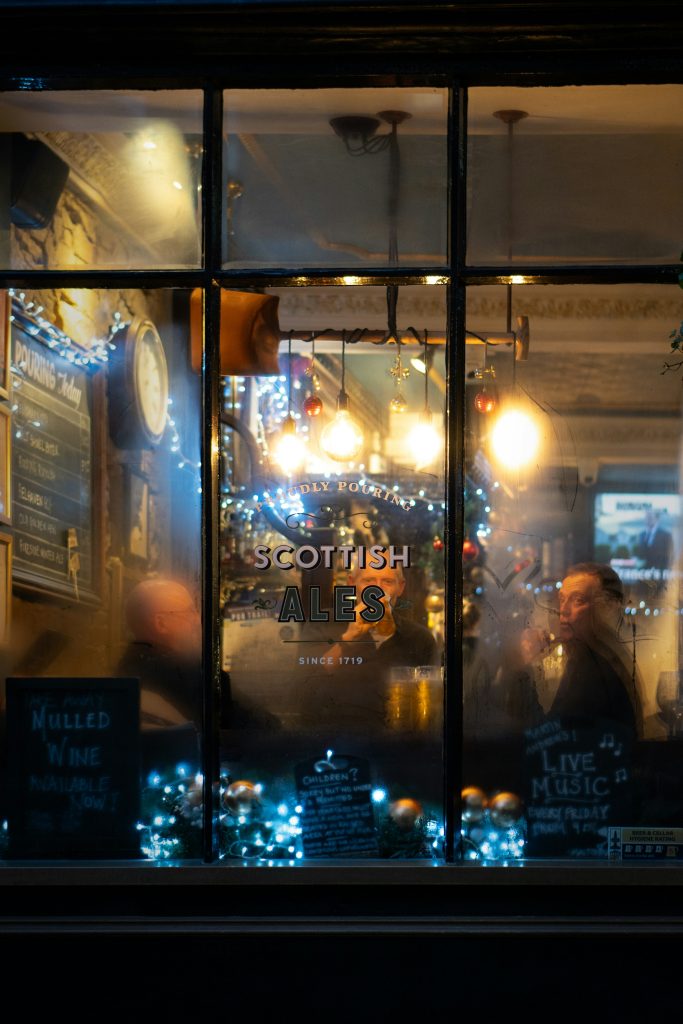 People inside traditional Edinburgh pub at night