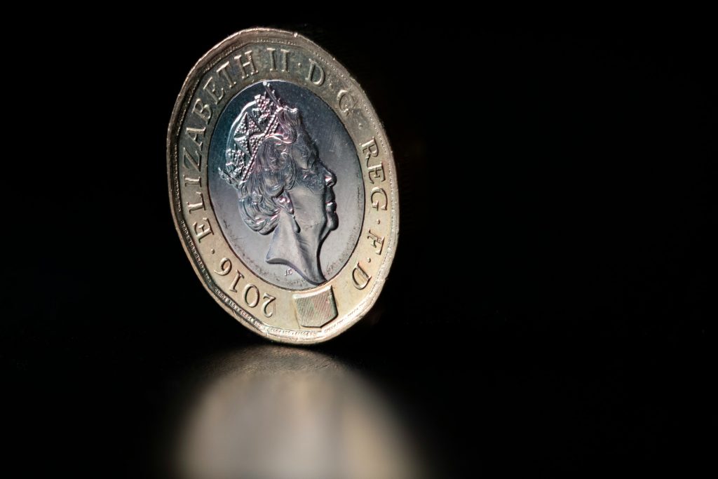 British pound coin on dark background